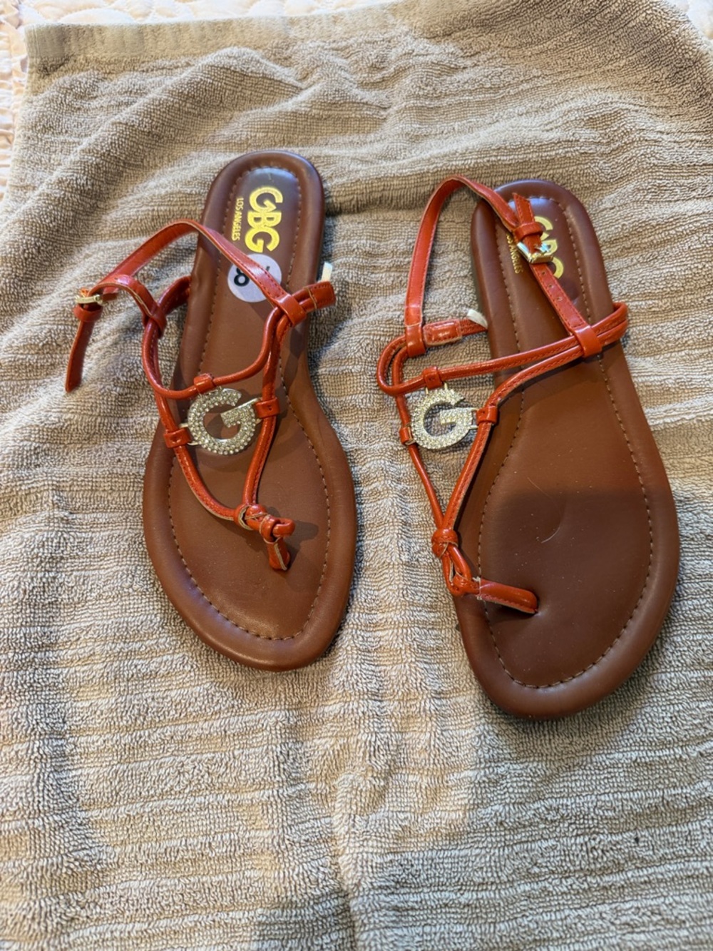 G by Guess Red-Orange Strappy T‑Bar Sandals with Gold G Accent